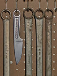 One-piece 425 high carbon stainless steel construction. Due to the forging process, each knife will have a unique look. Large lanyard hole mimicking a typical forged wrench. Easily attaches to a carabiner. Includes a black plastic sheath. Dimensions: 7.13” overall length, 3” blade.